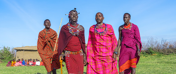 four Maasai Mara men showing traditional Maasai jumping dance
