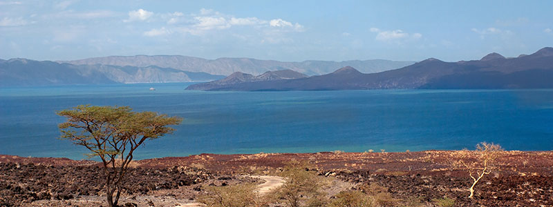 the road down to Lake Turkana with the expansive waters and hills in the background